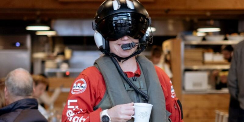 Life Flight Corporate Partner - Flight Coffee - person wearing crew helmet and gear while holding coffee