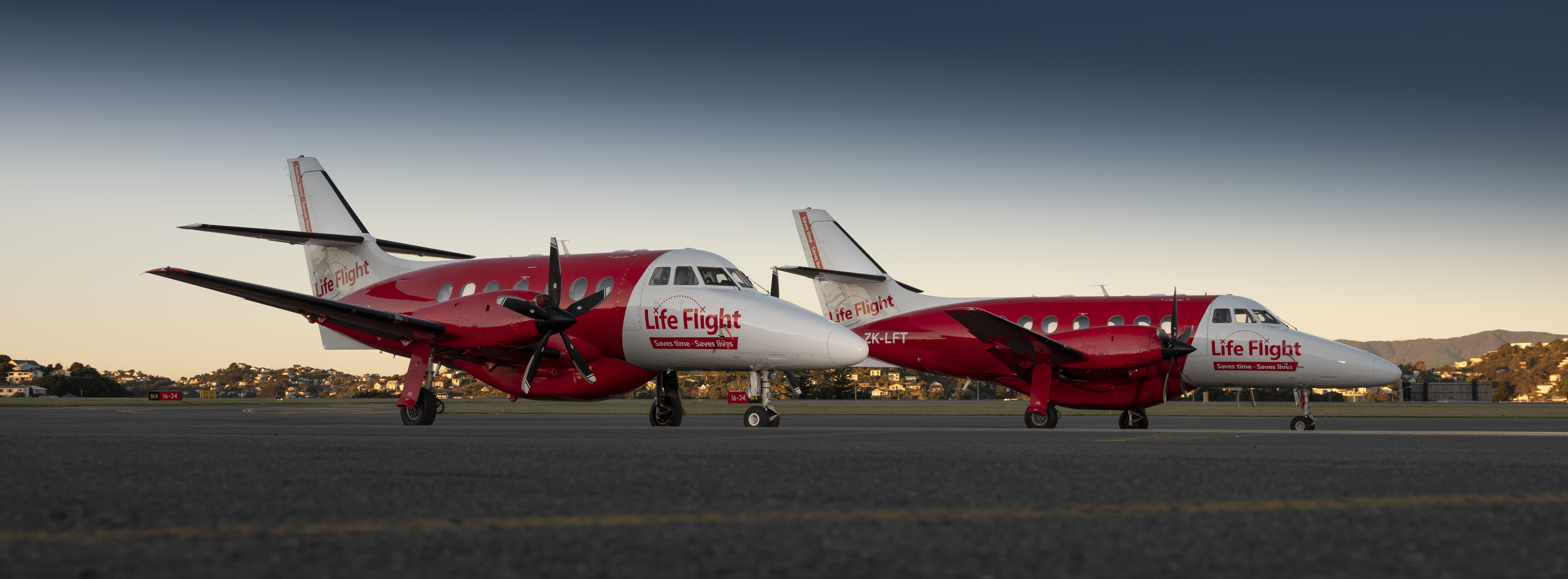 Two Life Flight Planes on airport tarmac at dusk