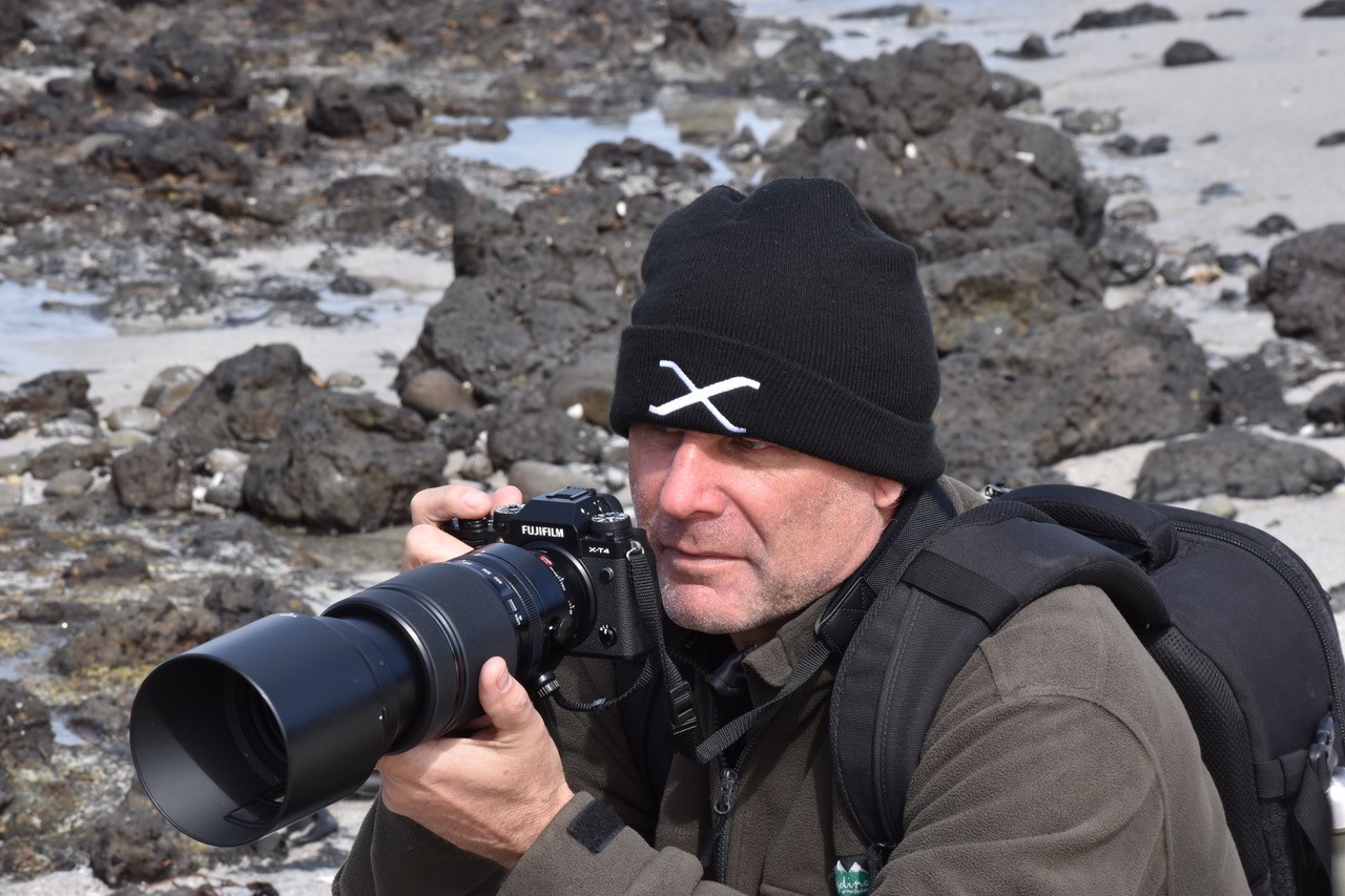 Man outside in the cold with a DSLR camera