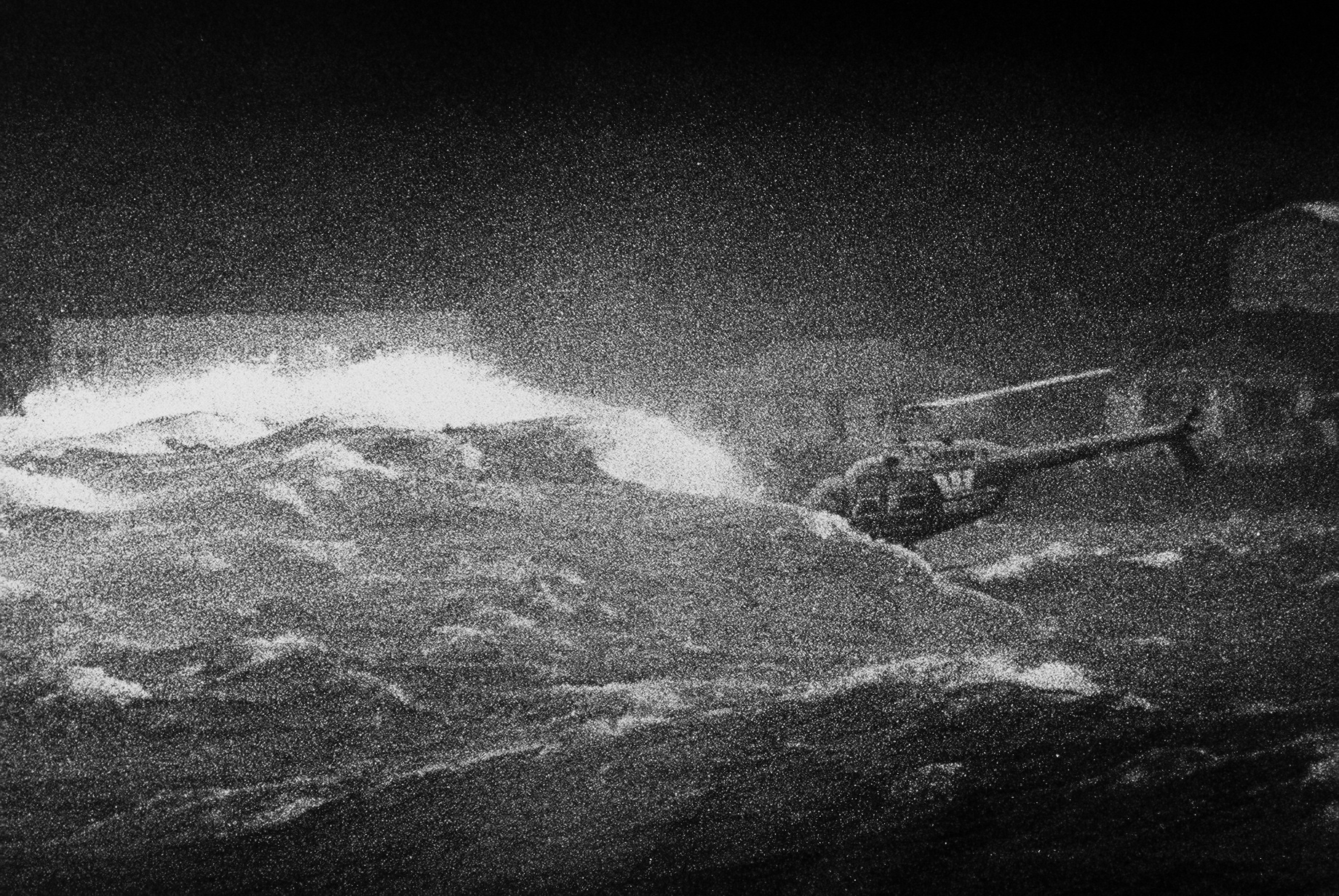 Westpac Rescue Helicopter hovering low over wild sea