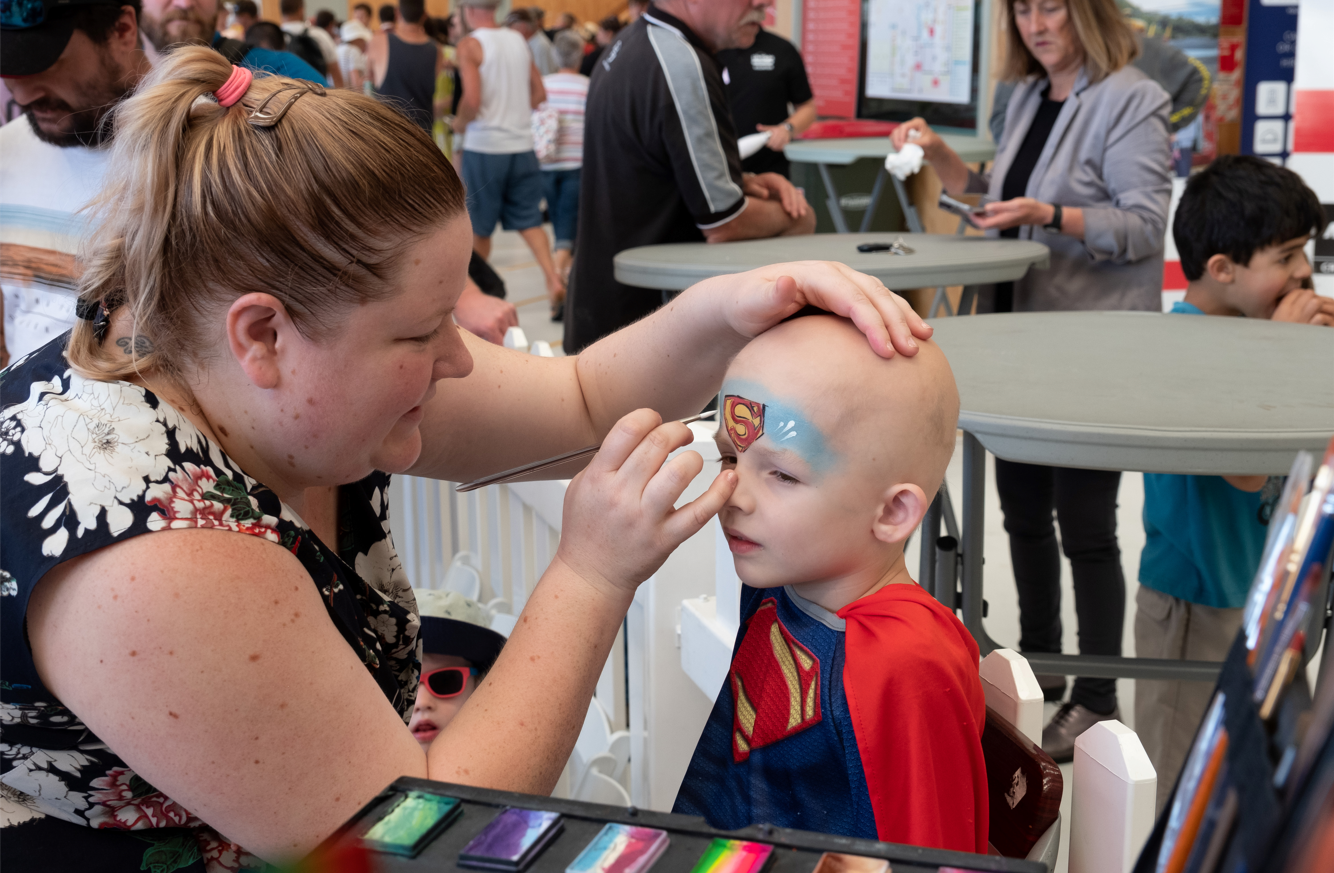 Volunteer painting childs face