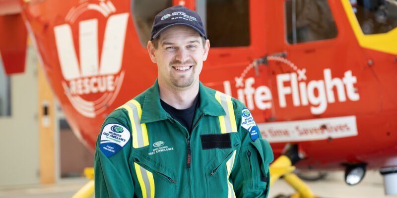 Paramedic in uniform standing infront of the Westpac rescue Helicopter