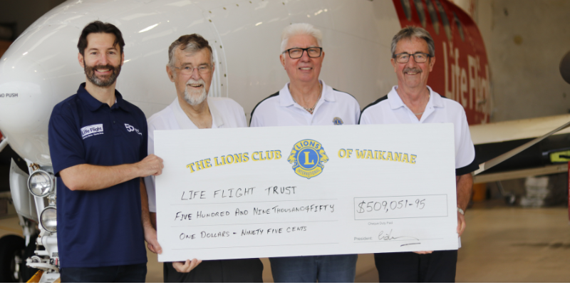 Three members of the Lions handing over $509,051.95 cheque to Sebastian Grodd, Head of Life Flight's Marketing and Fundraising